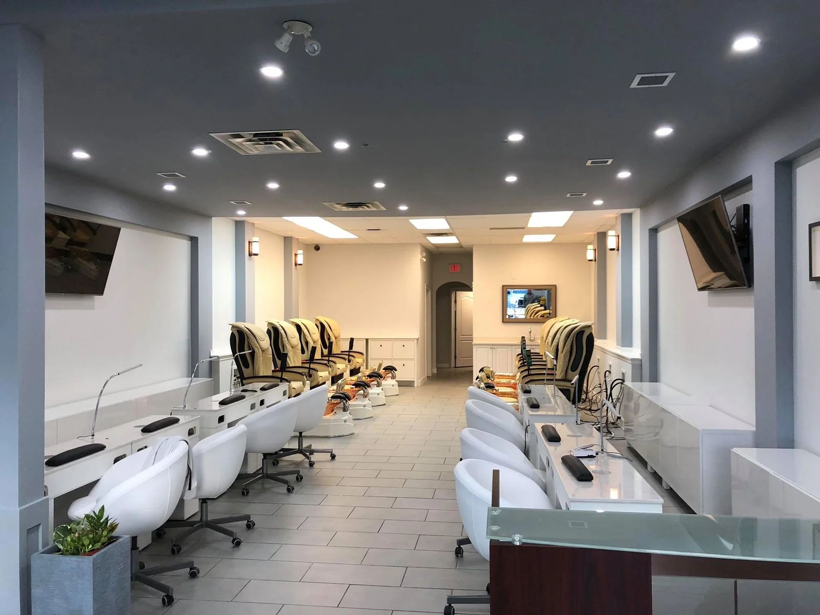 Inside JV Nails & Spa — pedicure chairs and manicure stations